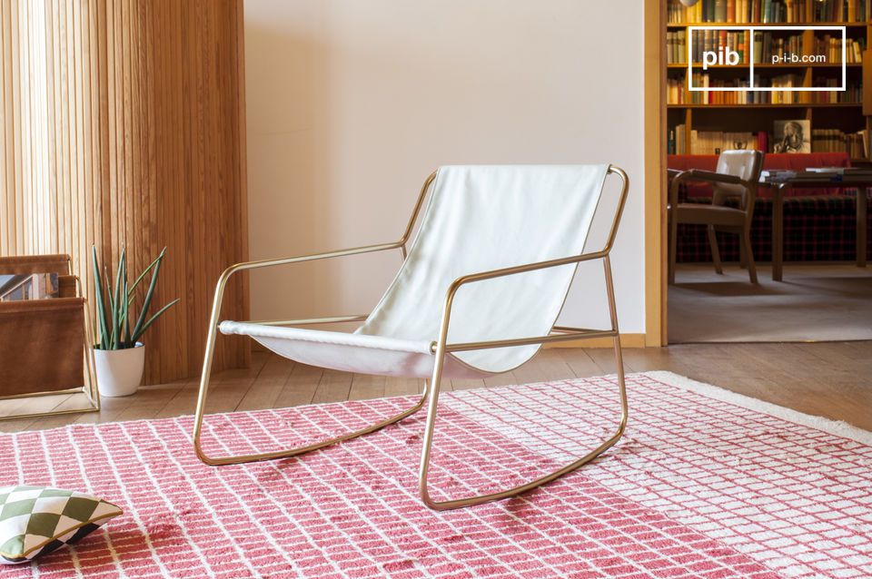 Elegant rocking chair in white canvas with a golden structure.