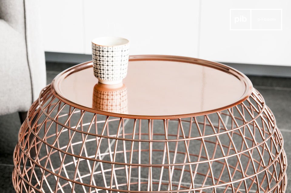 The table top is removable, made of a pretty pink copper metal.