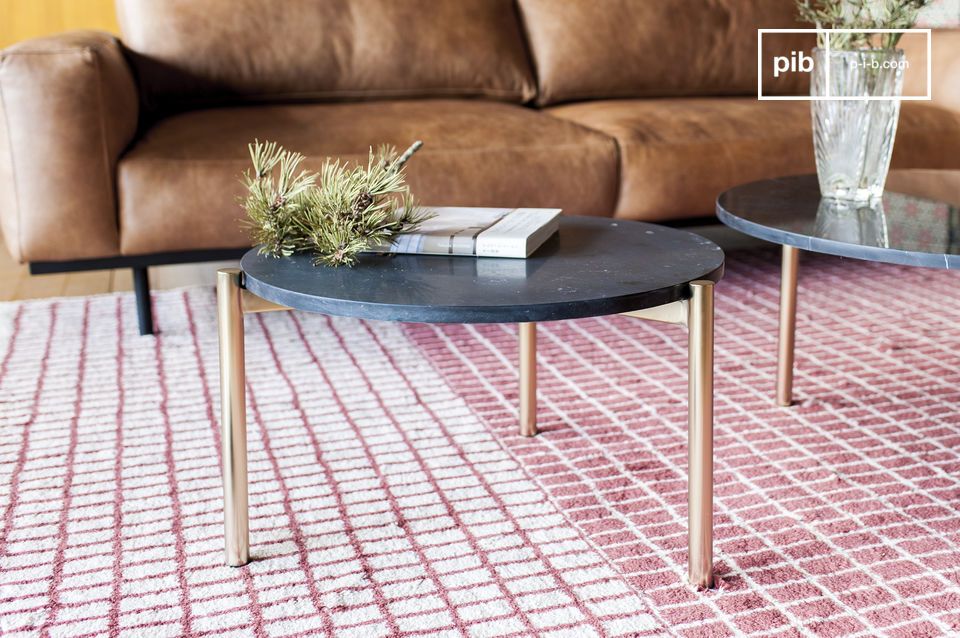 Attractive round coffee table in black marble with a gilded base.