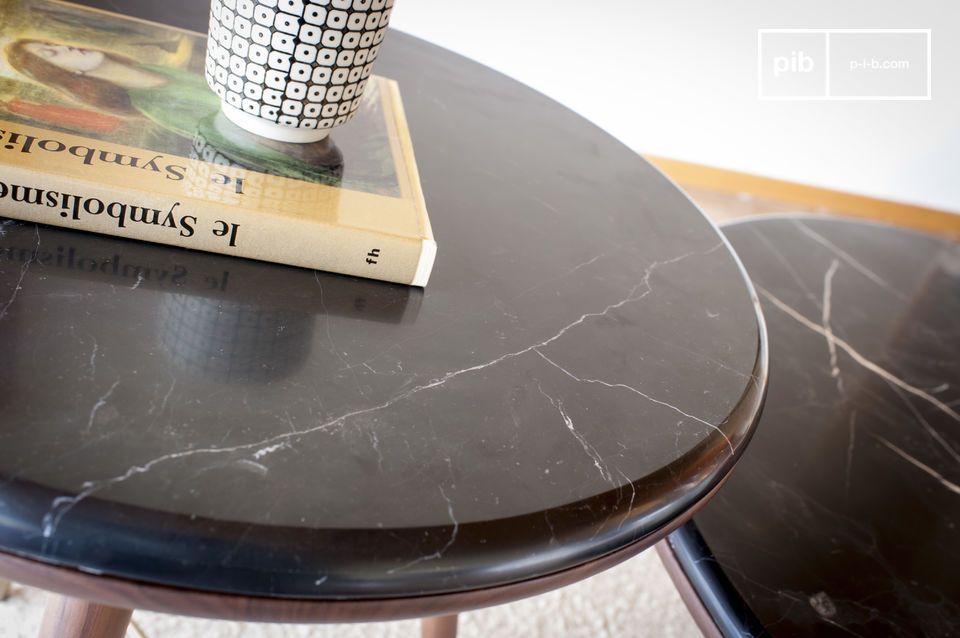 The large black marble top is veined with white.