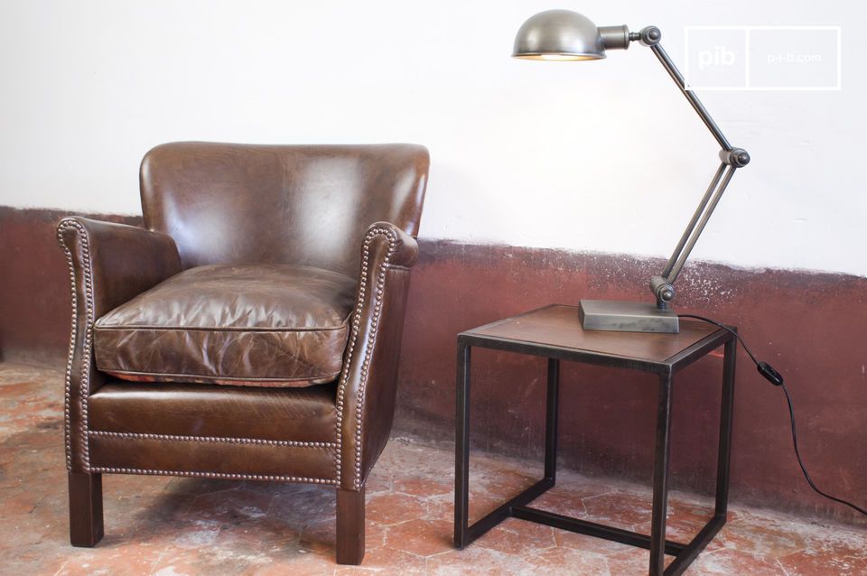 Club armchair harmoniously combined with a retro articulated lamp.