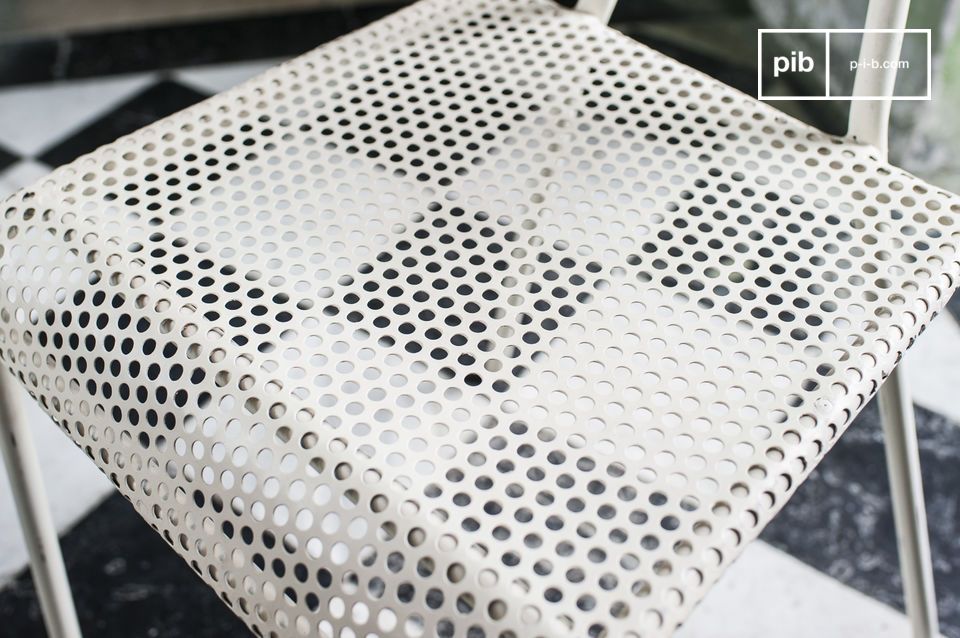 The seat is made of thick white perforated sheet metal.