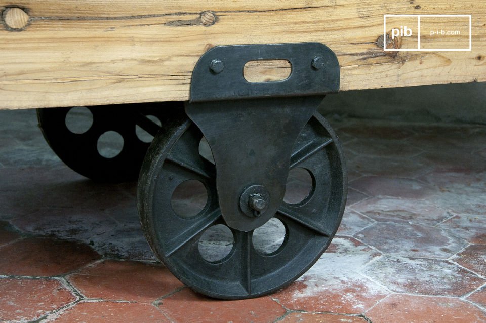 the table is made of thick varnished wood, and mounted on cast iron wheels.